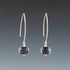 Black Sparkling Earrings (Long Ear Wires) by Becky Congdon are handmade black glass beads with silver dots encased in clear. The beads dangle from long contemporary simple ear wires. Each bead has small silver saucers on each side of it.