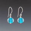 Aquamarine Sparkling Earrings (Ear Wires) by Becky Congdon are handmade glass beads. Each bead is a transparent aquamarine with tiny silver dots then encased in clear. Each bead dangles from simple Bali silver ear wire with tiny silver saucers on either side of the bead.