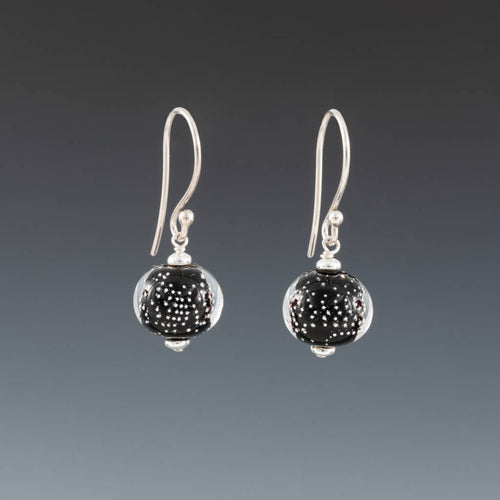 Black Sparkling Earrings (Ear Wires) by Becky Congdon are handmade glass beads with tiny silver balls encased in clear over black. Earrings are assembled with sterling silver saucers and dangle from Bali ear wires.