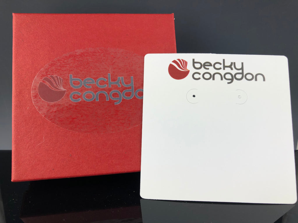 Dark cherry red cotton gift box and white earring card with Becky Congdon's logo at the top as well as on the box.