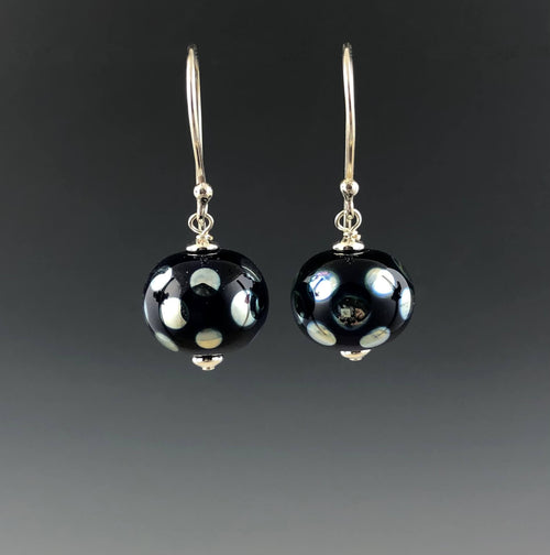 Dark cobalt blue round beads with mirror dots with silver saucer beads hanging on Bali silver earwires by Becky Congdon.